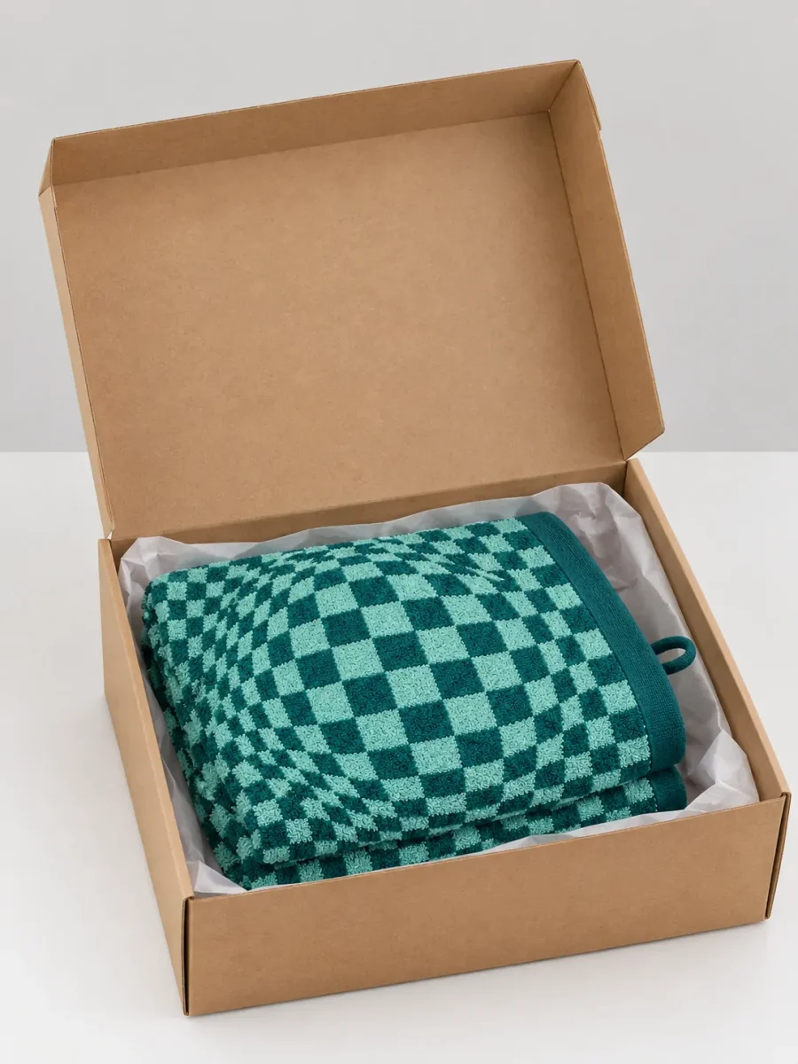 A folded towel in a plain cardboard box